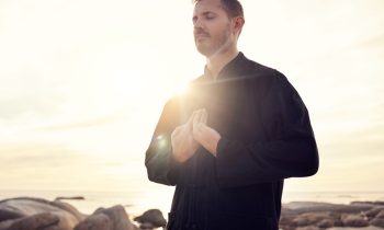 Meditation, zen and tai chi with man at beach for spiritual, fitness and healing energy at sunrise